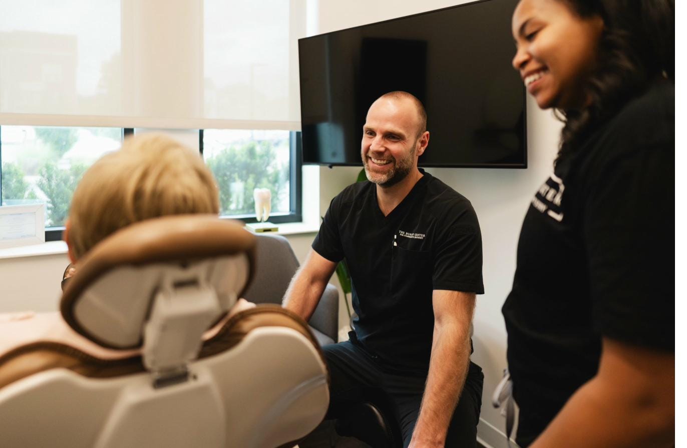 Dr. Will and a hygienist with a patient